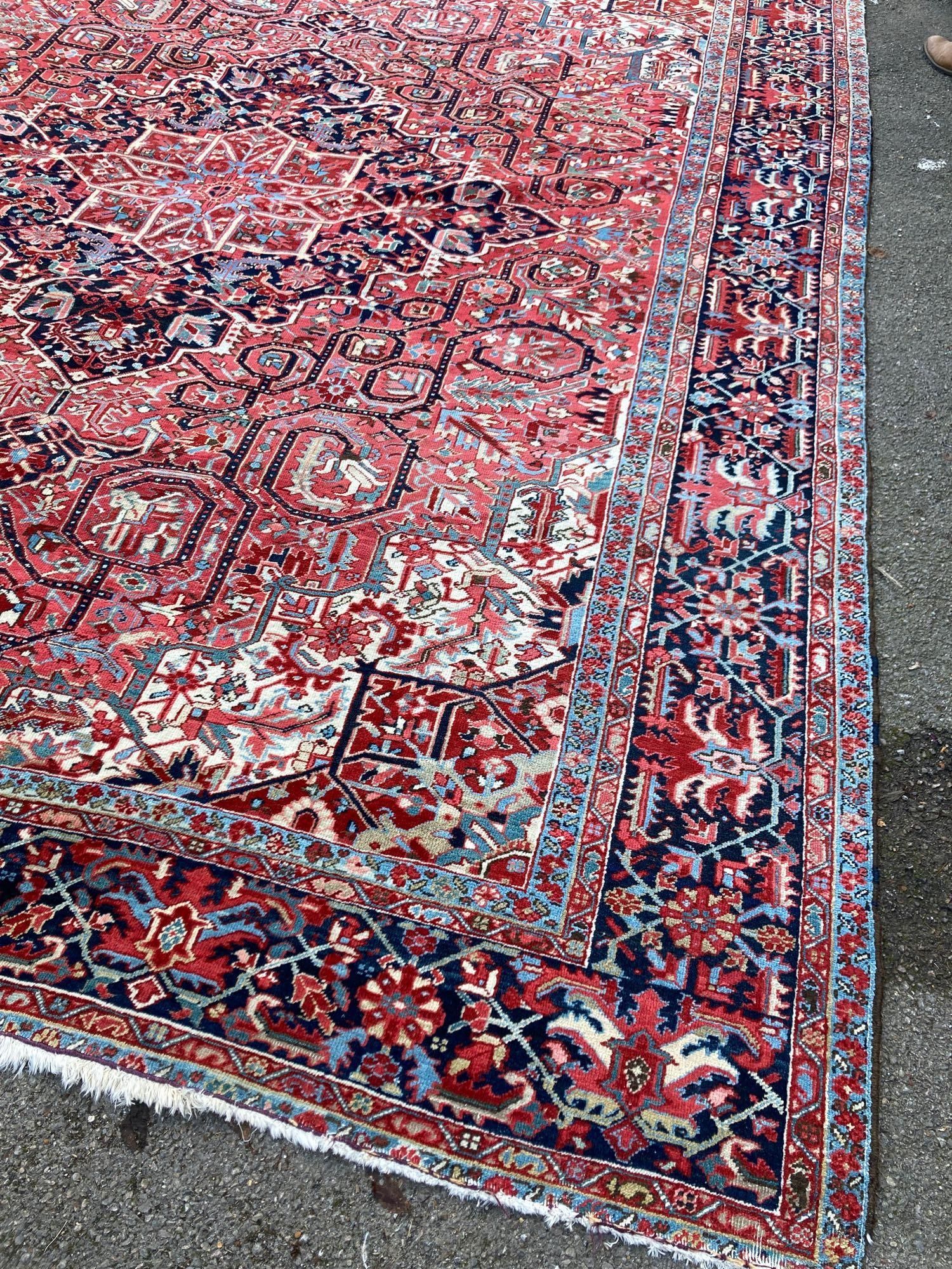 A large Persian red ground carpet, 444 x 347cm